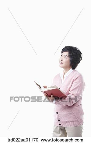 An elderly woman looking at the sky with a book View Large Photo Image Stock Image - An elderly woman looking at the sky with a book. Fotosearch