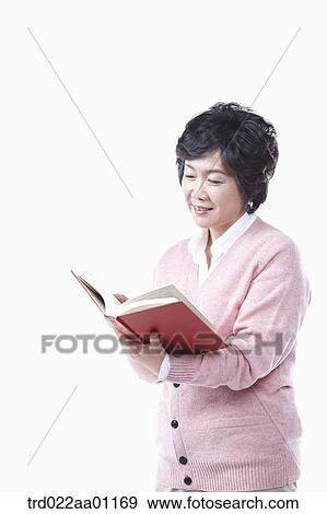 Stock Photo - An elderly woman reading a book. Fotosearch
