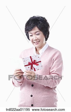 An elderly woman reading a card View Large Photo Image Stock Photography - An elderly woman reading a card. Fotosearch