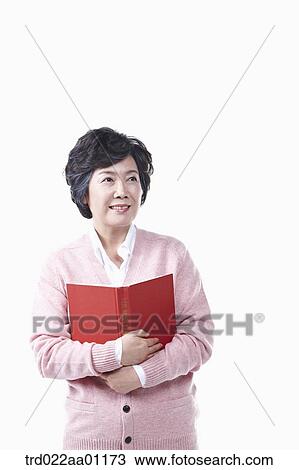 An elderly woman with a book View Large Photo Image Stock Image - An elderly woman with a book. Fotosearch