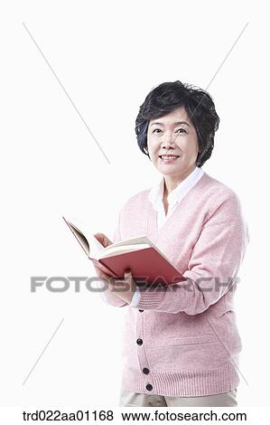 An elderly woman with a book View Large Photo Image Stock Photo - An elderly woman with a book. Fotosearch