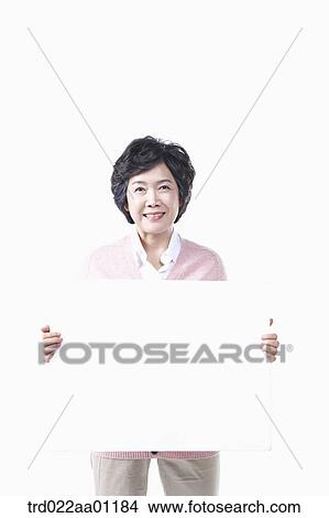 Picture - An elderly woman with a white board. Fotosearch