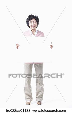 Stock Image - An elderly woman with a white board. Fotosearch