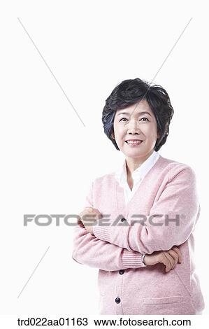 Stock Image - An elderly woman with her arms folded. Fotosearch