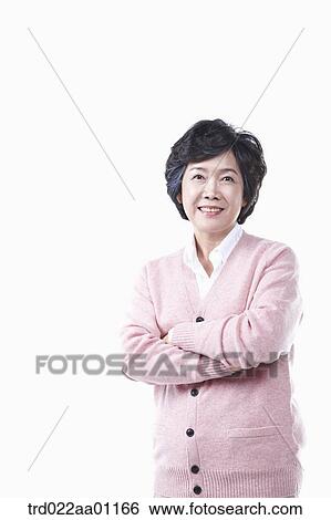 An elderly woman with her arms folded View Large Photo Image Stock Photograph - An elderly woman with her arms folded. Fotosearch