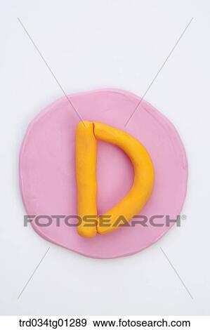 Stock Photo - The alphabet D shaped orange clay on the pink circle clay . Fotosearch