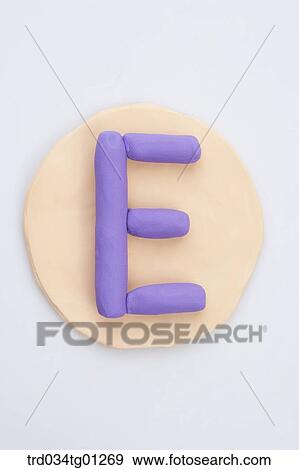 Stock Photo - The alphabet E shaped purple clay on the orange circle clay . Fotosearch