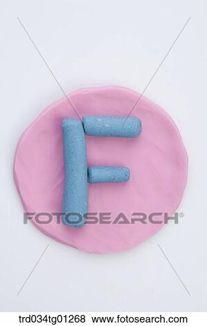 The alphabet F shaped blue clay on the pink circle clay View Large Photo Image Stock Photo - The alphabet F shaped blue clay on the pink circle clay . Fotosearch