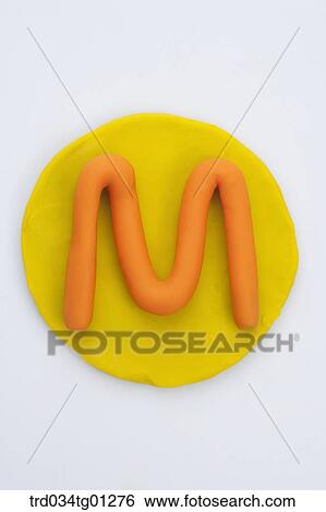The alphabet M shaped orange clay on the yellow circle clay View Large Photo Image Stock Photograph - The alphabet M shaped orange clay on the yellow circle clay . Fotosearch