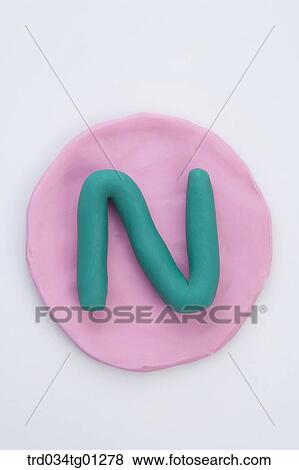 The alphabet N shaped green clay on the pink circle clay View Large Photo Image Stock Photo - The alphabet N shaped green clay on the pink circle clay . Fotosearch