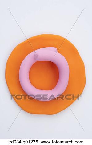 The alphabet O shaped pink clay on the orange circle clay View Large Photo Image Stock Photography - The alphabet O shaped pink clay on the orange circle clay . Fotosearch