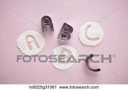 The alphabet shaped cookie cutters and the dough View Large Photo Image Stock Image - The alphabet shaped cookie cutters and the dough. Fotosearch