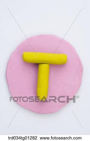 The alphabet T shaped yellow clay on the pink circle clay View Large Photo Image Stock Image - The alphabet T shaped yellow clay on the pink circle clay . Fotosearch