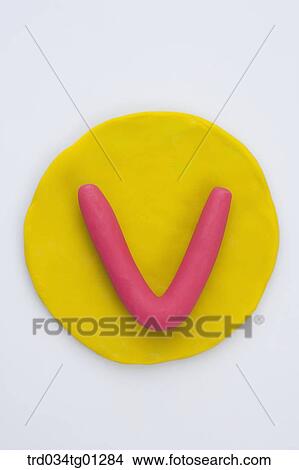 Picture - The alphabet V shaped red clay on the yellow circle clay . Fotosearch