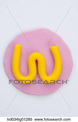 The alphabet W shaped yellow clay on the pink circle clay View Large Photo Image Stock Photography - The alphabet W shaped yellow clay on the pink circle clay . Fotosearch
