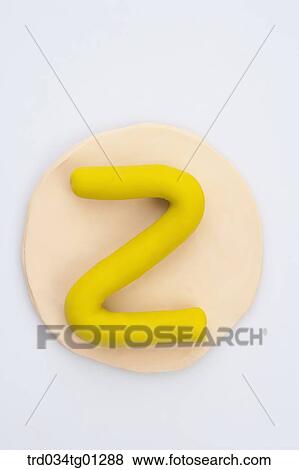 The alphabet Z shaped yellow clay on the orange circle clay View Large Photo Image Stock Photo - The alphabet Z shaped yellow clay on the orange circle clay . Fotosearch