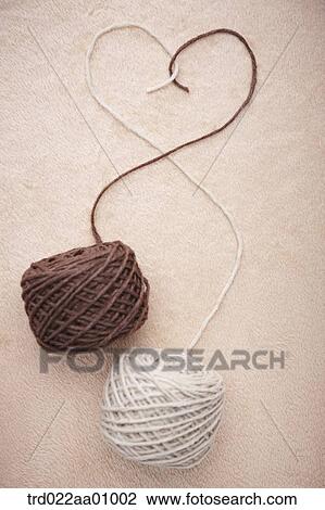 The balls of brown and ivory wool making the heart View Large Photo Image Stock Image - The balls of brown and ivory wool making the heart . Fotosearch