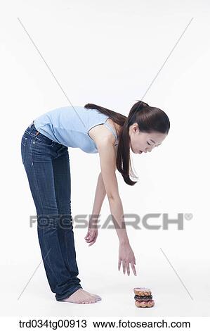 The bending down woman over the doughnuts View Large Photo Image Stock Image - The bending down woman over the doughnuts. Fotosearch