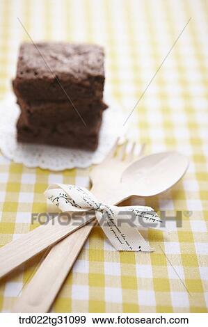 The brownie and the wooden spoon and fork with ribbon View Large Photo Image Stock Photo - The brownie and the wooden spoon and fork with ribbon . Fotosearch