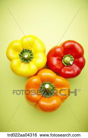 Stock Photograph - The colorful bell peppers with the green background. Fotosearch