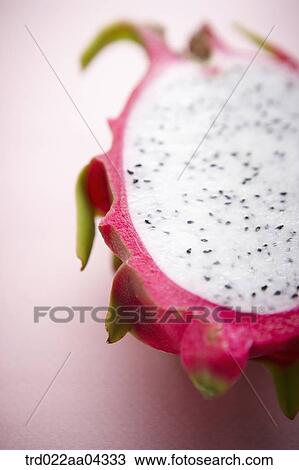 Stock Image - The dragon fruit in half with the pink background. Fotosearch