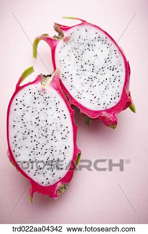 Stock Image - The dragon fruit in half with the pink background. Fotosearch