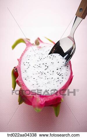 The dragon fruit in half with the spoon in it View Large Photo Image Stock Photo - The dragon fruit in half with the spoon in it. Fotosearch