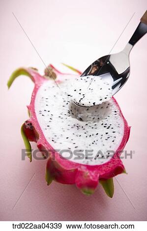 The dragon fruit in half with the spoon in it View Large Photo Image Stock Photo - The dragon fruit in half with the spoon in it. Fotosearch