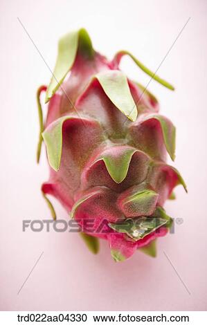 Stock Image - The dragon fruit with the pink background. Fotosearch