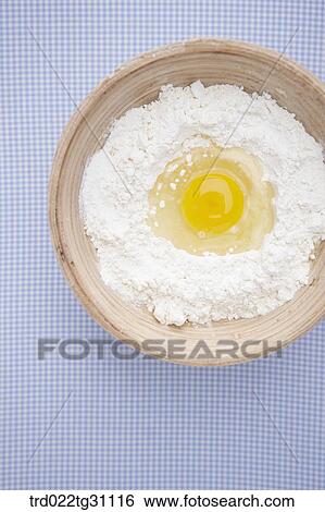 The egg in the bowl of flour View Large Photo Image Stock Photograph - The egg in the bowl of flour. Fotosearch