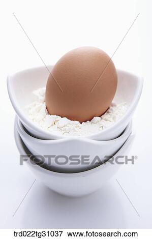 The egg in the piled bowl of flour View Large Photo Image Stock Photo - The egg in the piled bowl of flour. Fotosearch