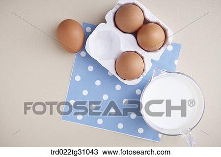 The eggs in the carton and a cup of milk on the blue polka dots napkin View Large Photo Image Stock Image - The eggs in the carton and a cup of milk on the blue polka dots napkin. Fotosearch