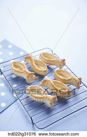 Stock Photograph - The fish shaped cookie on the baking ware. Fotosearch