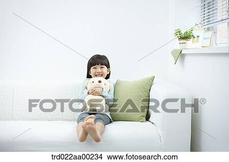 Picture - The girl hugging the teddy bear . Fotosearch