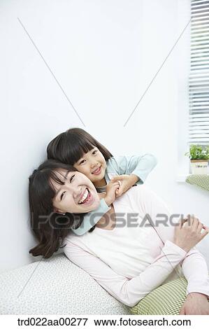 The girl hugging the woman from back View Large Photo Image Stock Photo - The girl hugging the woman from back. Fotosearch