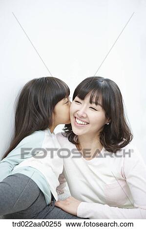 The girl kissing on woman's cheek View Large Photo Image Stock Photography - The girl kissing on woman's cheek. Fotosearch