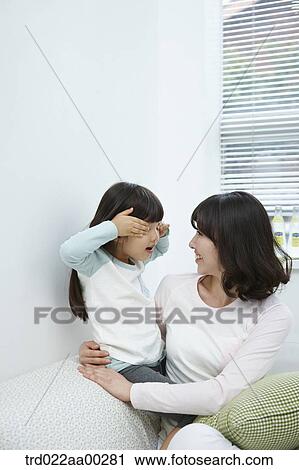 The girl playing with the woman View Large Photo Image Stock Image - The girl playing with the woman . Fotosearch