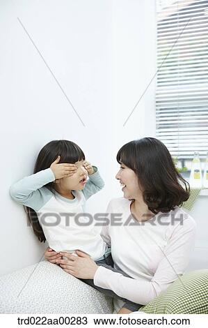 Stock Image - The girl playing with the woman . Fotosearch