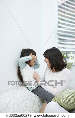 The girl playing with the woman View Large Photo Image Stock Photo - The girl playing with the woman . Fotosearch