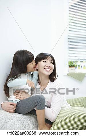 The girl whispering in woman's ear View Large Photo Image Stock Photo - The girl whispering in woman's ear. Fotosearch