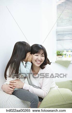 The girl whispering in woman's ear View Large Photo Image Stock Photography - The girl whispering in woman's ear. Fotosearch