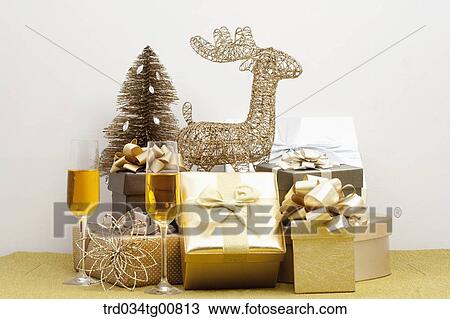 Stock Image - The gold Christmas table decorations with gold drink of glasses. Fotosearch
