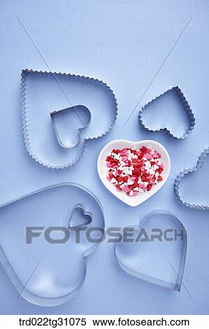 The heart shaped cookie cutters with the dish of heart decorating sugar View Large Photo Image Stock Photography - The heart shaped cookie cutters with the dish of heart decorating sugar. Fotosearch