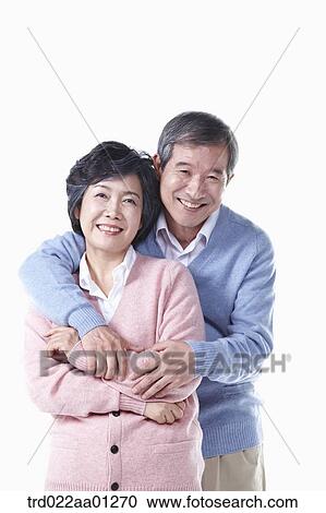 Stock Image - The hugging elderly man and woman . Fotosearch