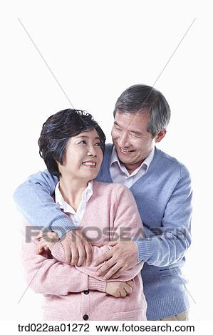 Stock Image - The hugging elderly man and woman . Fotosearch