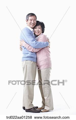 Stock Photo - The hugging elderly man and woman . Fotosearch