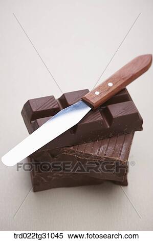 The knife on the piled chocolate View Large Photo Image Stock Photography - The knife on the piled chocolate . Fotosearch