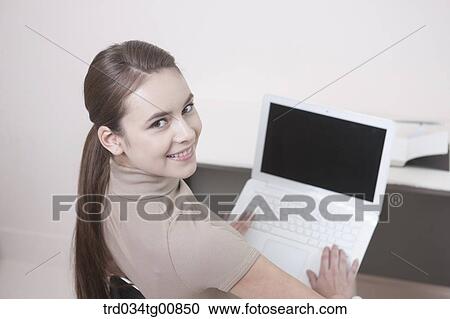 Stock Image - The looking up woman with the laptop . Fotosearch