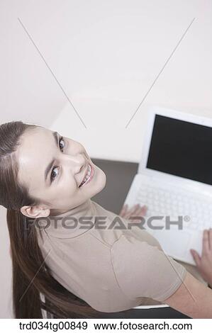 Stock Photo - The looking up woman with the laptop . Fotosearch