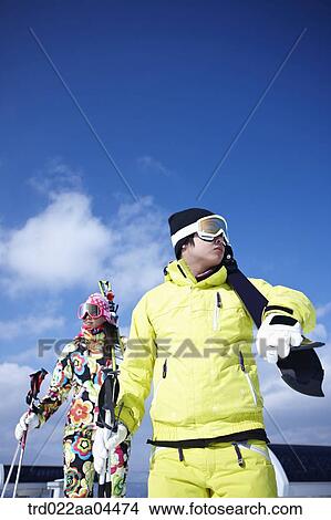 The man and woman wearing skiwear with the ski gear View Large Photo Image Picture - The man and woman wearing skiwear with the ski gear. Fotosearch